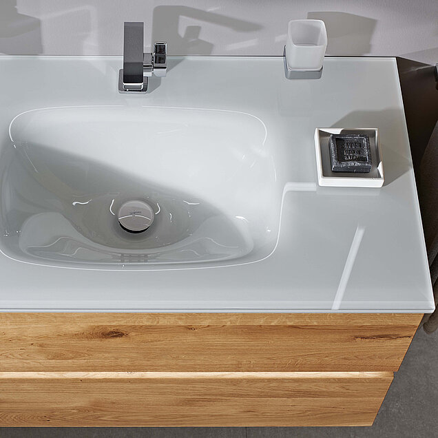 Waschbecken mit einem rechteckigen weißen Becken, einem silbernen Wasserhahn.