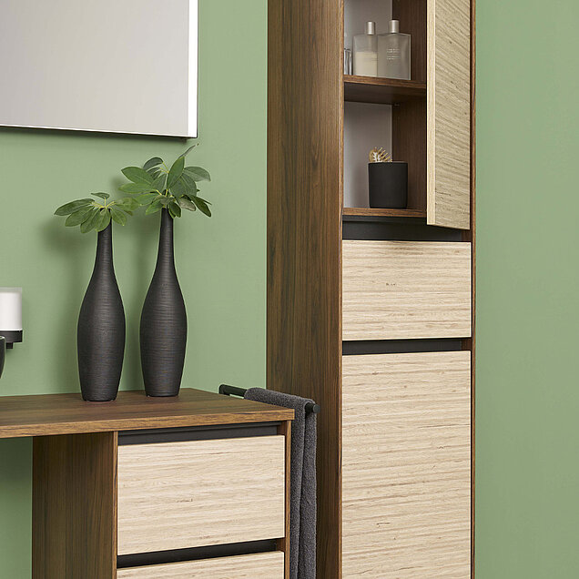 Badezimmer mit Holzschränken, zwei hohen schwarzen Vasen und Toilettenartikeln in offenen Regalen